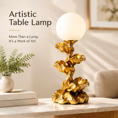 Gold-tone floral globe lamp beside books and greenery with artistic table lamp text