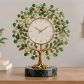 Round-canopy green leaf tree clock with a white dial, gold-tone trunk and dark green veined circular base